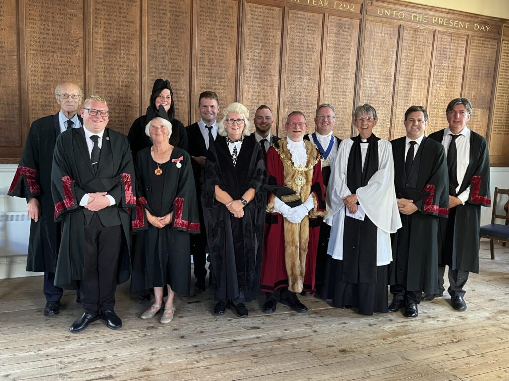 A photograph showing the Mayor of Faversham, Town Councillors, Town Clerk and Mayor's Chaplain taken after the reading of King Charles III's Proclamation at the Guildhall, Faversham